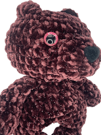 a brown teddy bear with pink eyes