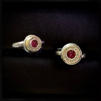 two rings with red stones on them